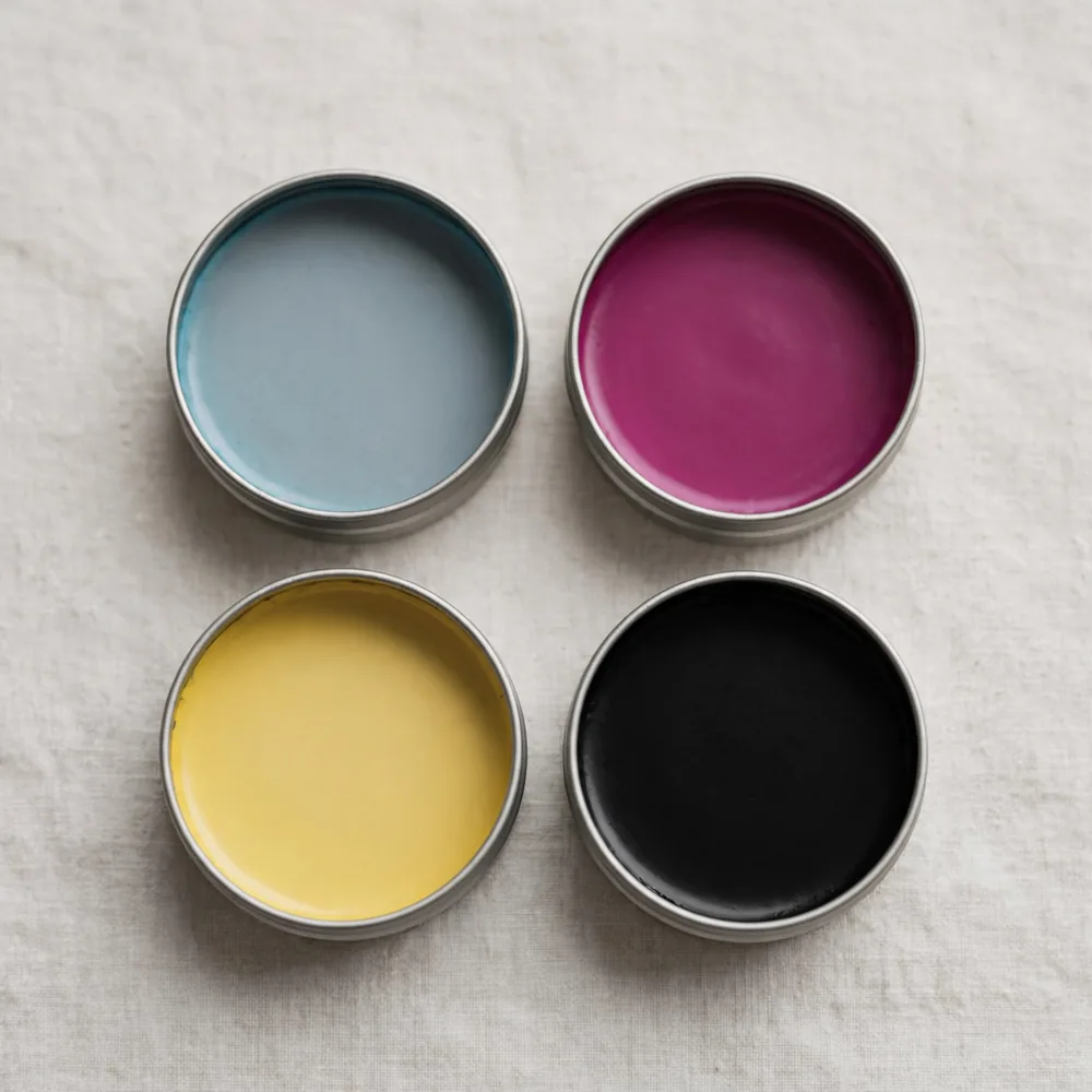 Four tins of printing ink